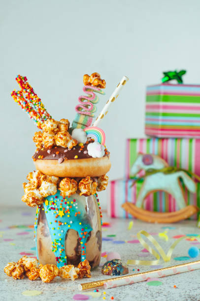 istock Chocolate freak shake topping with donut and caramel popcorn on the party table 1143122039
