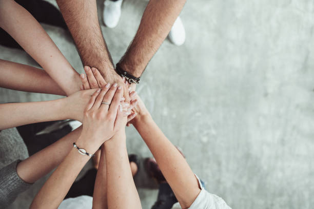 istock Group of friends stack their hands together, teamwork concept 1143123328