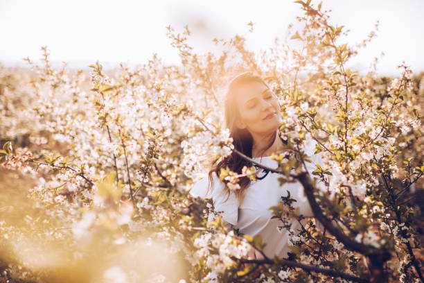 istock Girl in spring cherry garden 1143124121