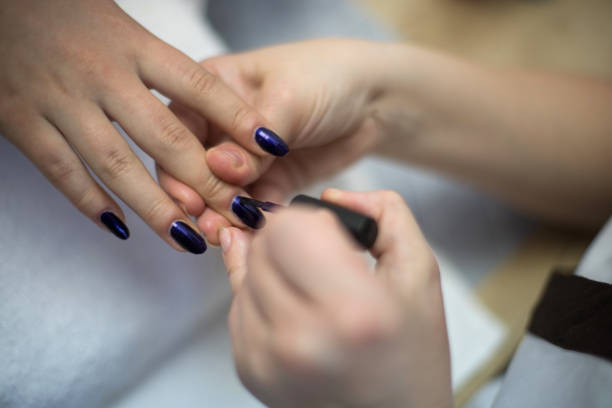 istock Manicurist painting a nail. 1143125158