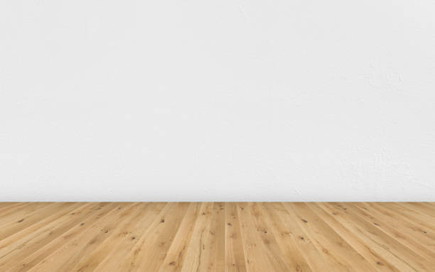 istock Empty room with brown wooden floor and white painted wall. Empty loft room for design interior. Long wide picture of empty living space room. 1143127574