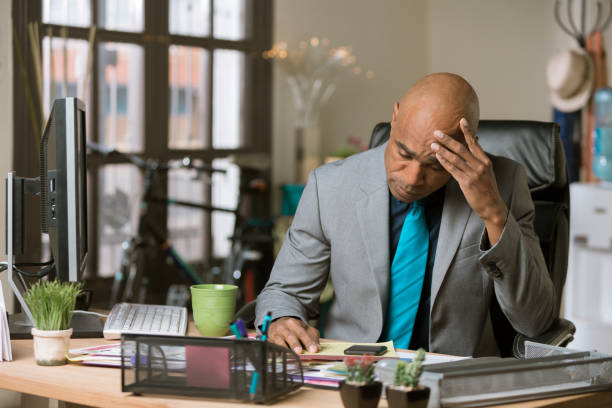 istock Overwhelmed Man in a His Office 1143128473