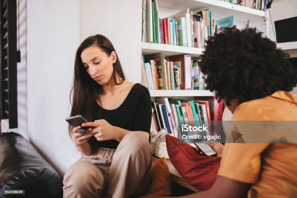 Roommates - Shared Payment Young women living together and sharing payment Financial Bill Stock Photo