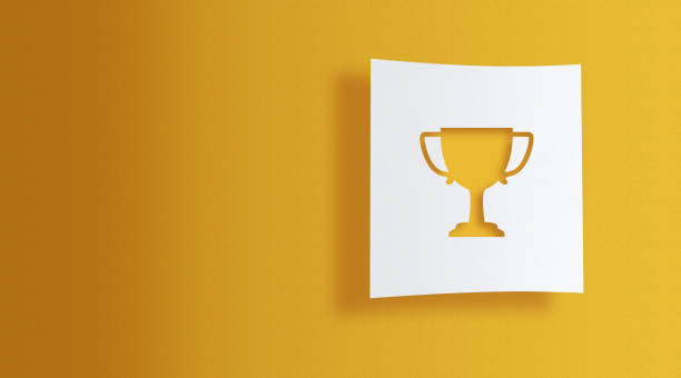 istock trophy on white information paper on yellow background 1143129347