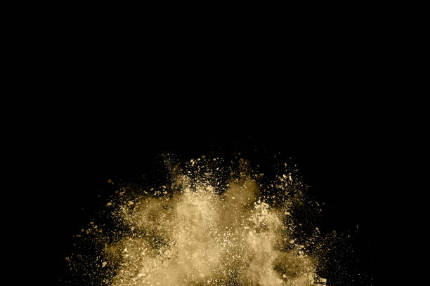 istock Golden powder explosion on black background. Freeze motion. 1143129586