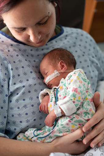 Mother taking care of his premature baby at hospital. Color and horizontal photo was taken in Quebec Canada.