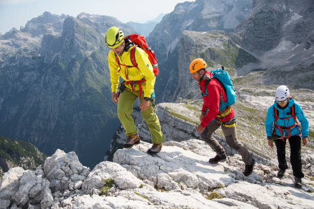 istock Group of mountaineers walking on the edge 1143133158