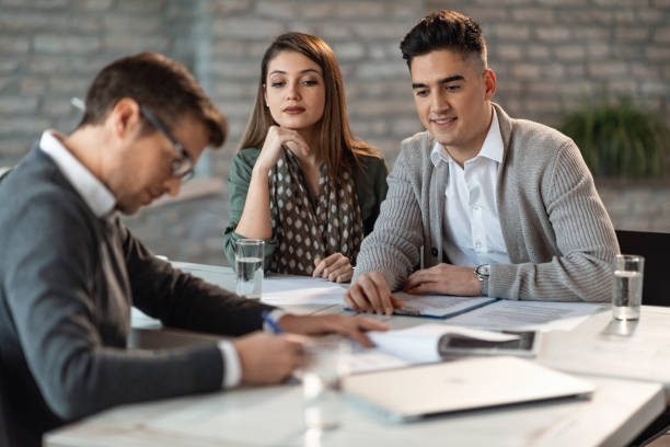 istock Young couple on a meeting with their insurance agent. 1143135642
