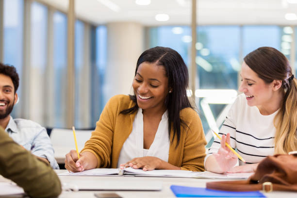 istock Smiling college girl works on project 1143140598