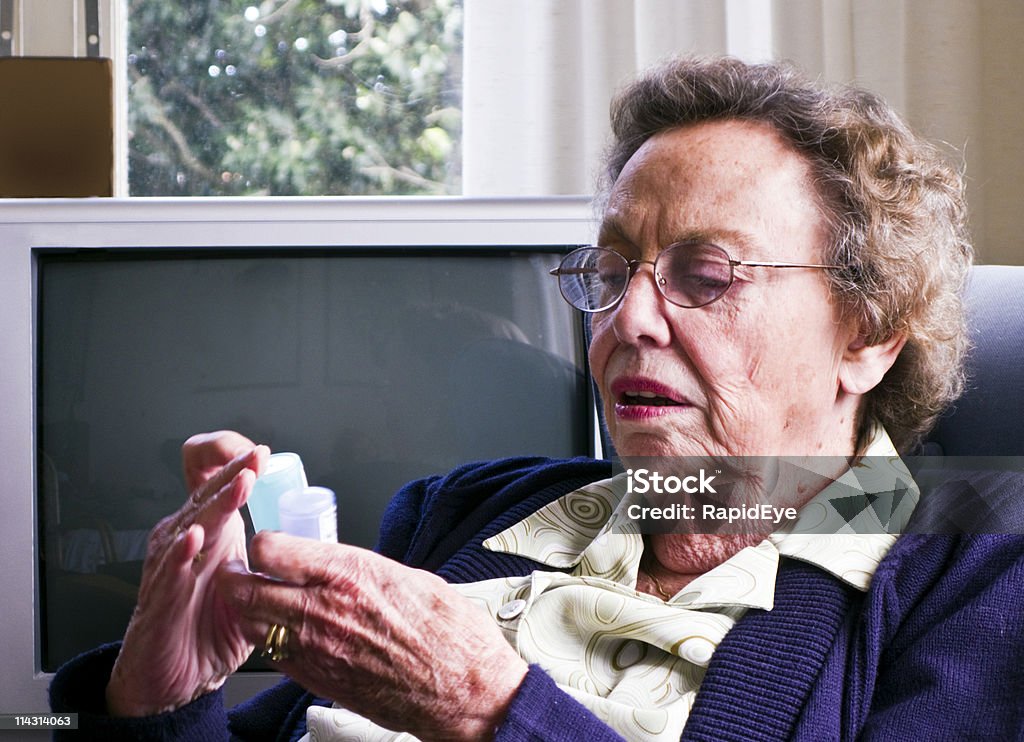 Checking her pills  80-89 Years Stock Photo