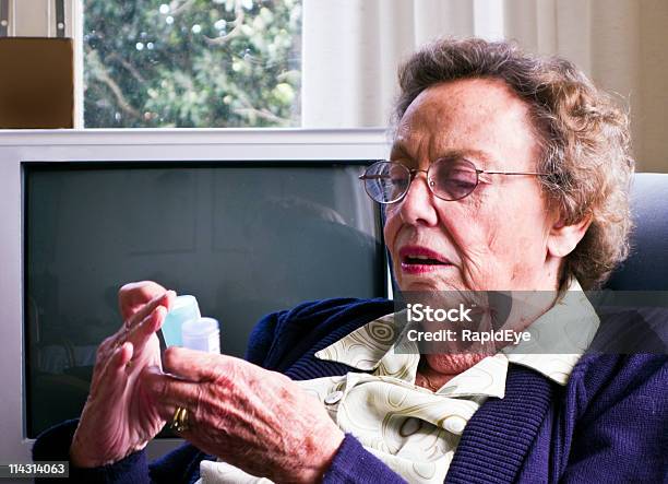 Checking Her Pills Stock Photo - Download Image Now - 80-89 Years, Adult, Adults Only