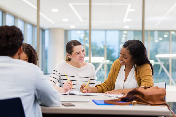 istock Cheerful female college students studying in library 1143140643