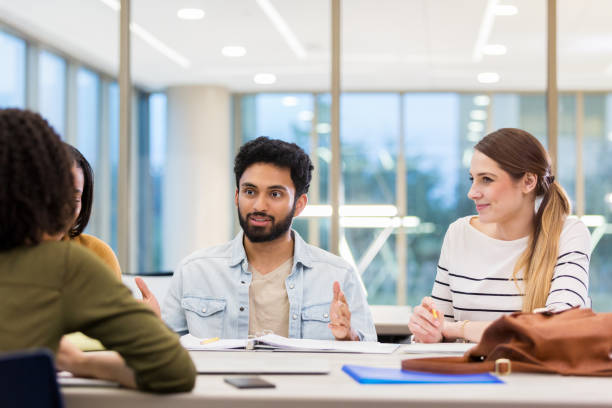 istock Male college student works on group project 1143140650