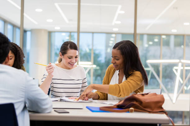 istock Cheerful college friends study for exam 1143140661