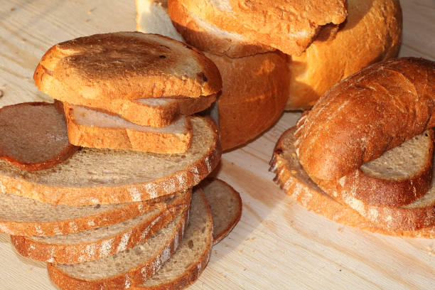 istock A loaf and slices of fresh bread on a sunny table 1143143050