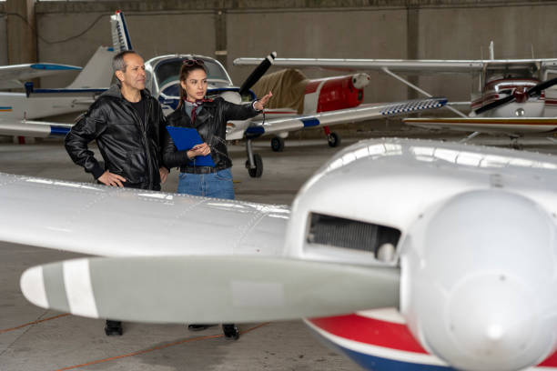 istock Student Pilot and Instructor Check an Aircraft for Safety in a Hangar 1143146654