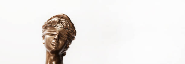 istock Justice blindfolded lady holding scales and sword statue 1143150380