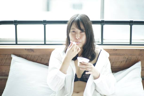 istock Young woman is eating pudding in bed 1143160719