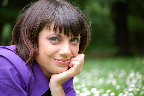 Head shot of girl smiling in natural setting