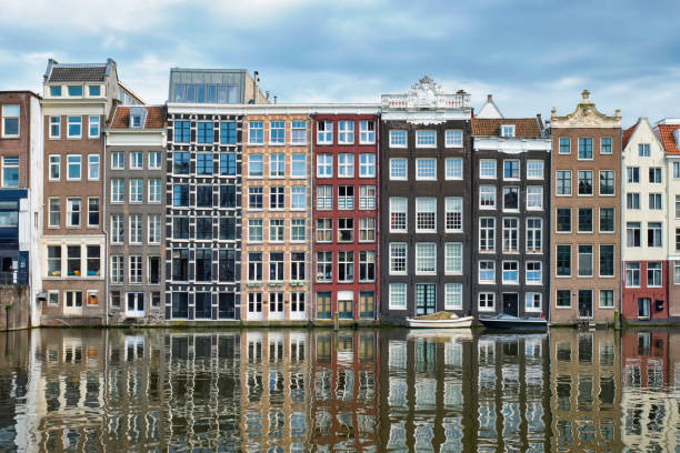 istock Amsterdam canal Damrak with houses, Netherlands 1143163427