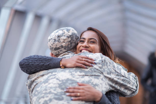 istock Woman hugging her partner after returning home from service 1143163591
