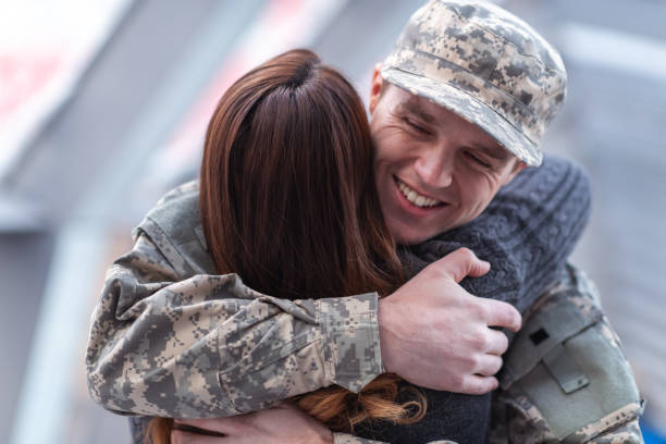 istock Man hugging his wife after returning home from service 1143163594