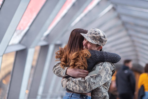 istock Woman hugging her partner after returning home from service 1143163595