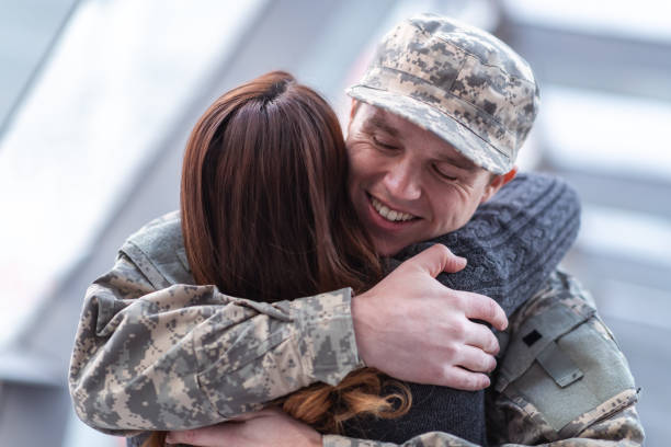 istock Man hugging his wife after returning home from service 1143163596