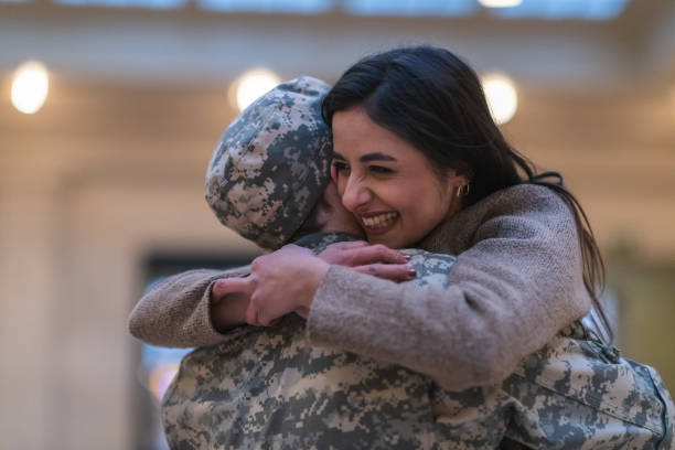 istock Woman hugging her husband after returning home from service 1143163599