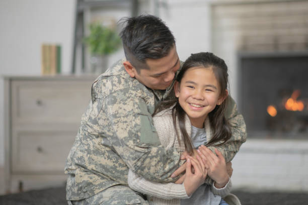 istock Military Dad Hugging His Young Daughter 1143163736