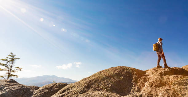 istock Man walking on the edge of a cliff 1143164680