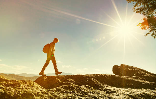 istock Man walking on the edge of a cliff 1143164750