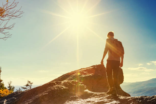 istock Man walking on the edge of a cliff 1143164762