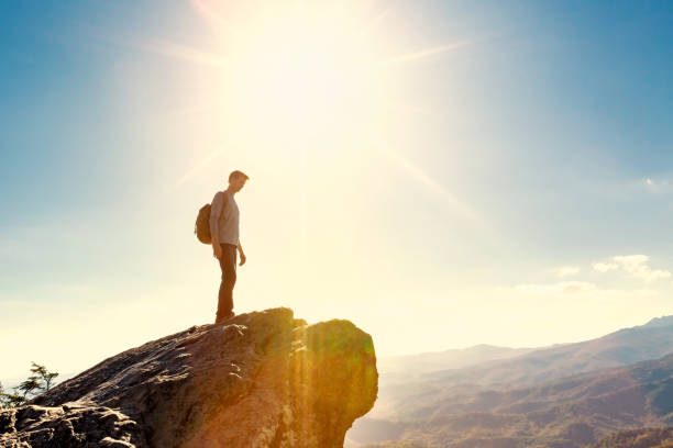 istock Man walking on the edge of a cliff 1143164770