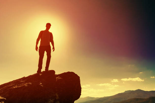 istock Man walking on the edge of a cliff 1143165325