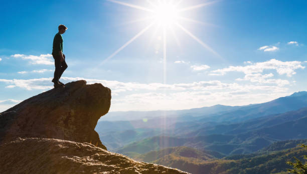 istock Man walking on the edge of a cliff 1143165329