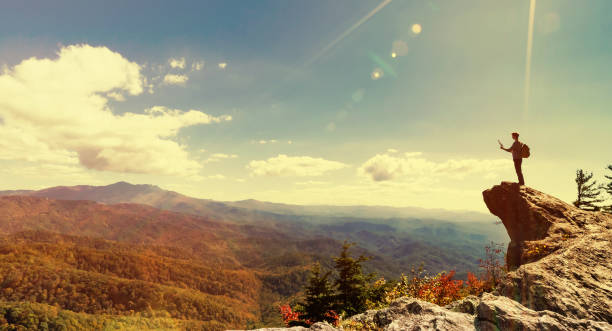 istock Man walking on the edge of a cliff 1143165380