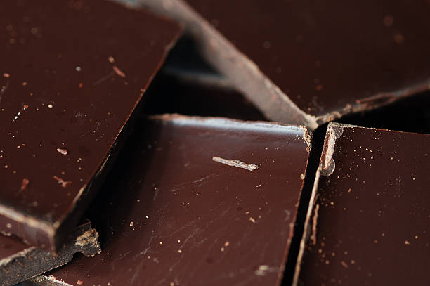 Close-up of dark chocolate pieces Pieces of dark chocolate sour taste stock pictures, royalty-free photos & images