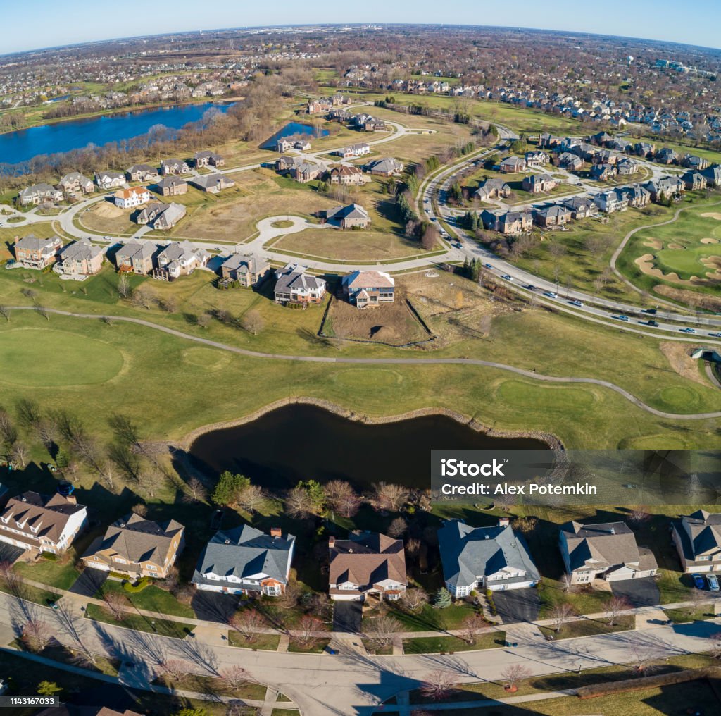 Drone aerial view of the pond in the residential neighborhood Libertyville, Vernon Hills, Chicago, Illinois. High resolution stitched panorama. The residential neighborhood in Chicago, Illinois, USA, at the spring early morning Suburb Stock Photo