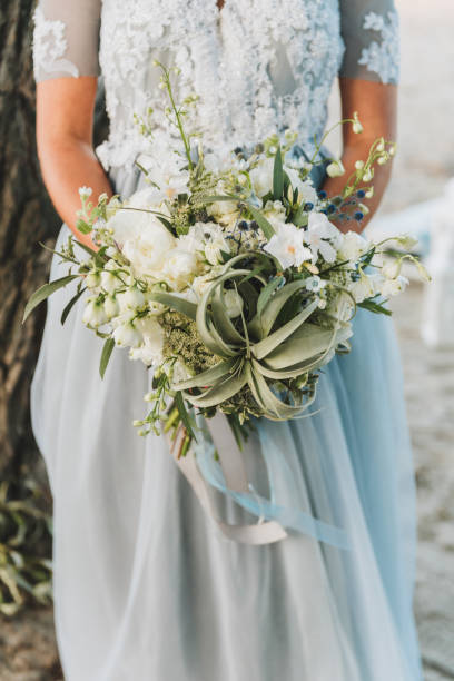 istock Bride wearing light blue wedding dress holding bouquet 1143171252