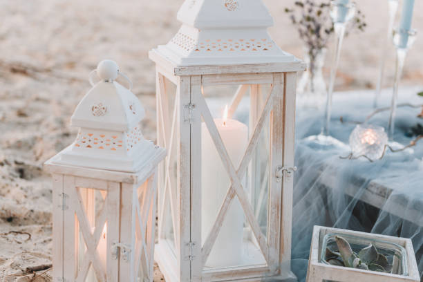 Big candles next to elegant table setup in blue pastels for a beach wedding