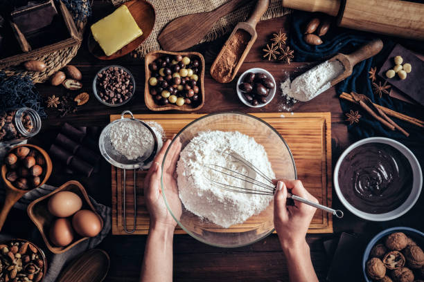 istock Woman hands making chocolate mousse and cookies on a wooden table in a rustic kitchen 1143172696