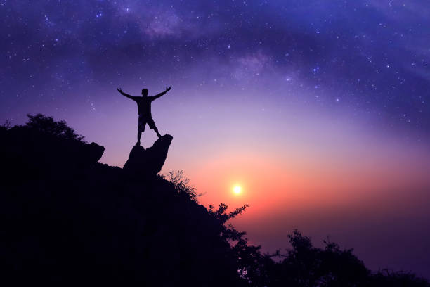 istock Man standing on the mountain with  million stars galaxy 1143177491