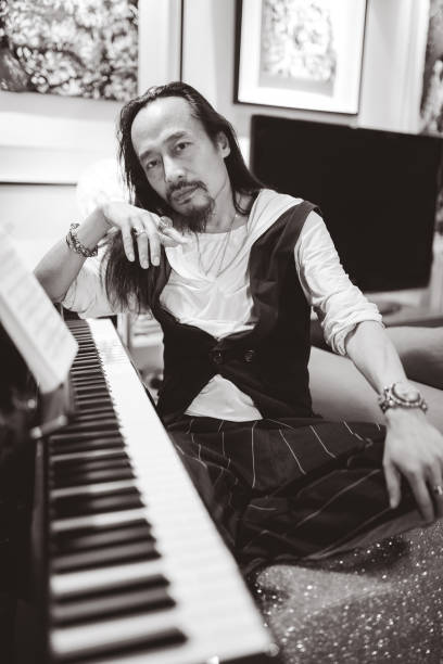 istock Hipster man sitting near piano 1143178671