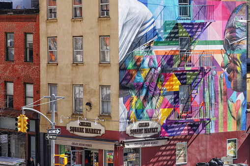 02 April 2019: Chelsea Square Market, Building at the corner of W 18th Street and 10th Avenue, Manhattan, New York, USA. Wall painting of Mother Teresa and Mahatma Gandhi created by Eduardo Kobra Mural.