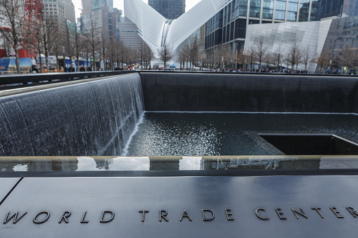 06 April 2019: The name of World Trade Center written on a marble near the 9/11 Memorial in Manhattan, New York City, USA.