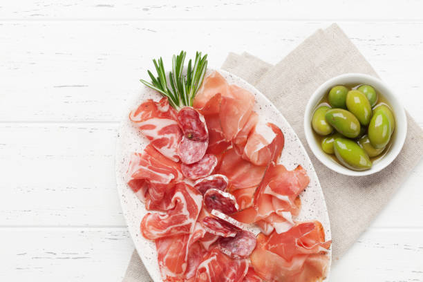 istock Spanish jamon, prosciutto crudo ham, italian salami 1143191887