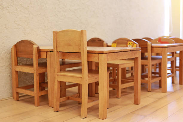 istock Small desk and chairs for kid in student classroom. 1143193243