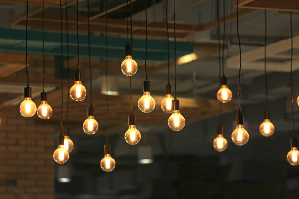 istock Vintage glowing light bulbs hanging. Decorative antique style light bulbs. 1143194545