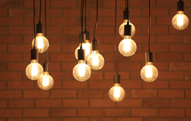istock Vintage glowing light bulbs hanging. Decorative antique style light bulbs. 1143194560